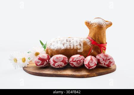 Easter lamb cake with decorated eggs and flowers Stock Photo