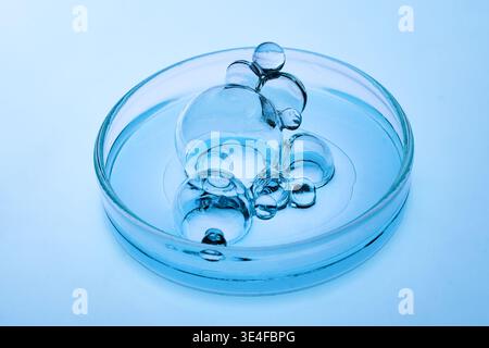 Abstract cosmetic lab. Bubbles forming in petri dish liquid science research Stock Photo