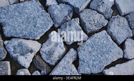 Broken concrete debris creating an abstract background texture from demolition site Stock Photo