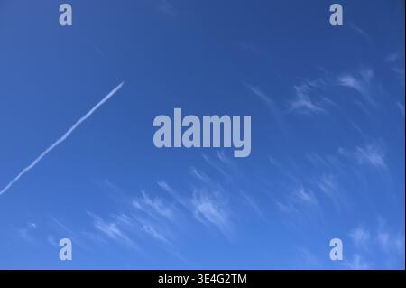 Feather clouds (cirrus) and contrails, in the blue sky, Bavaria, Germany Stock Photo