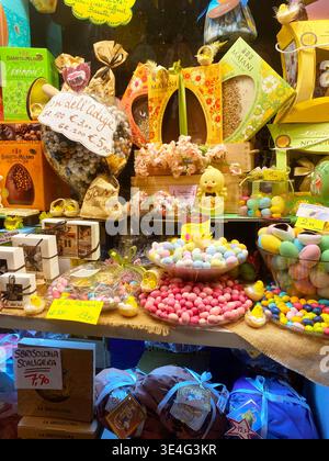 Verona, Italia - March 24, 2026: Colorful display of Easter-themed candies and chocolates in a shop window, featuring eggs, bunnies, and decorative Stock Photo