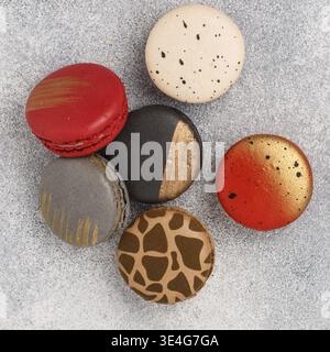 Food, Assorted multicolored macaroon cookies on a gray concrete background close-up. Sweet French macarons biscuits. Desert for gourmets. Selective fo Stock Photo