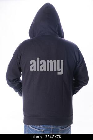 Back view of person wearing black blank hoodie isolated on light background Stock Photo