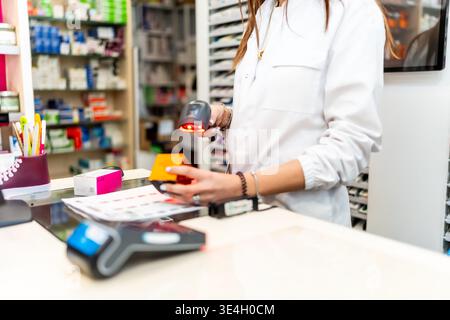 Pharmacist scanning product using barcode reader in drugstore Stock Photo