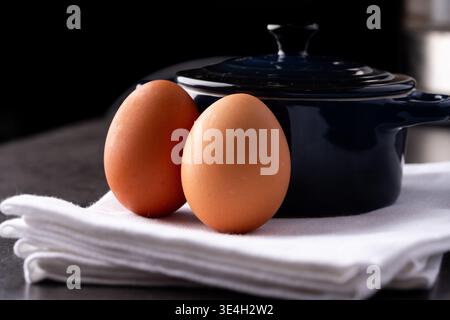 Two eggs with a crock pot in a kitchen Stock Photo