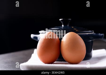 Two eggs with a crock pot in a kitchen Stock Photo