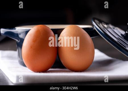 Two eggs with a crock pot in a kitchen Stock Photo