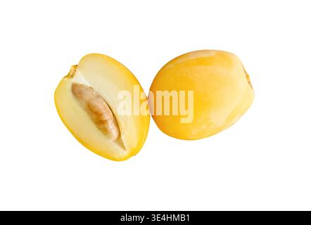 Fresh ripe yellow Barhi date palm fruit with a half in stack is isolated on white background with clipping path. Concept of iftar food in Ramadan for Stock Photo
