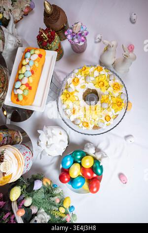 Beautiful overhead view of a festive Easter table covered with colorful desserts. Stock Photo