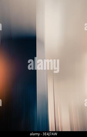Abstract vertical motion blur with soft beige and deep blue gradients, creating a minimal modern background. Subtle light streaks suggest speed, trans Stock Photo