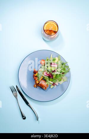 Top view of vegetable spring roll wrapped in rice paper with bell pepper, carrot, zucchini and wood ear mushrooms, served with salad mix, cherry tomat Stock Photo