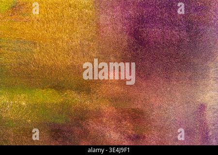 Abstract colored paint texture with soft blurring and layered brush strokes in purple, gold and green tones, creating a dreamy illustration-style back Stock Photo