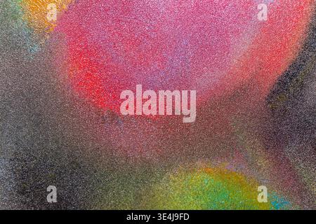 Abstract illustration of colored paint with soft blurring on a gritty textured surface, blending red, pink, green and blue tones into a moody modern b Stock Photo