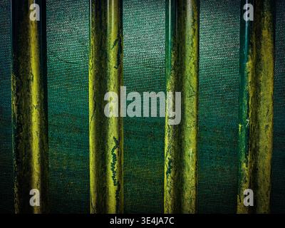Abstract green metal texture with vertical pipes and industrial pattern. Weathered surface with corrosion and grunge details. Stock Photo