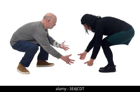 A woman and a man lifting something imaginary from the ground Stock Photo