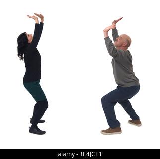side view of a woman and a man pushing or holding something imaginary Stock Photo