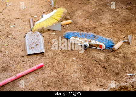 Dirty Work Tools on Soil Ground The Concept of Archaeology Stock Photo