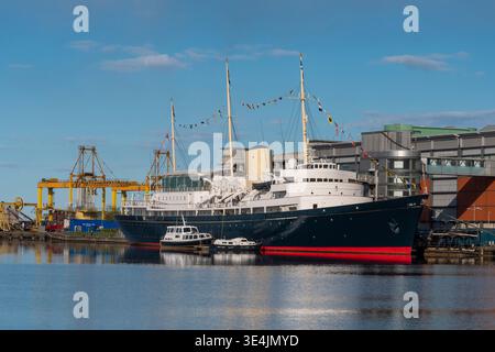 Royal Yacht Britannia rests moored at Ocean Terminal in Edinburgh, a historic museum ship offering maritime heritage, tourist attraction and calm wate Stock Photo