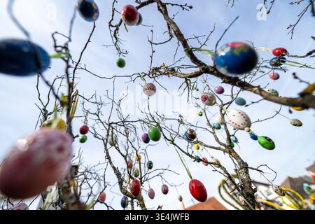 Bieberbach, Germany. 28th Mar, 2026. Numerous hand-painted eggs hang from an Easter bush next to the Easter fountain in Bieberbach. The Easter fountain in Franconian Switzerland is one of the largest in the world. In 2000, it made it into the Guinness Book of Records with exactly 11,108 hand-painted eggshells. This year it is decorated with around 10,000 eggs. Every year at Easter, the fountains in Franconia are decorated with colorful eggs and other Easter motifs, attracting numerous onlookers. Credit: Pia Bayer/dpa/Ģ����ý Live News Stock Photo