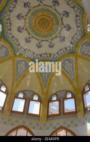 Elaborately decorated mosaic tile dome ceiling with scrollwork and bat motifs inside an Art Nouveau pavilion at Recinte Modernista de Sant Pau Stock Photo