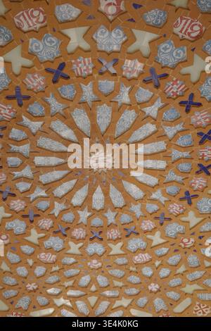 Intricate radial mosaic ceiling with heraldic motifs, star patterns, and blue and white ceramic tiles inside the Sagrada Familia basilica, Barcelona Stock Photo