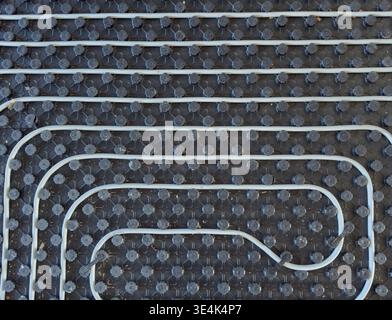 Radiant floor heating layout with pipes installed on thermal insulation Stock Photo