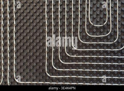 Radiant floor heating layout with pipes installed on thermal insulation Stock Photo