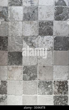 Old stone tiles pattern aged wall texture gray natural background Stock Photo