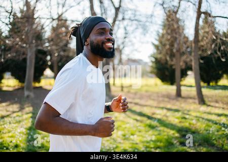 Fitness, running and black man in nature for exercise Stock Photo
