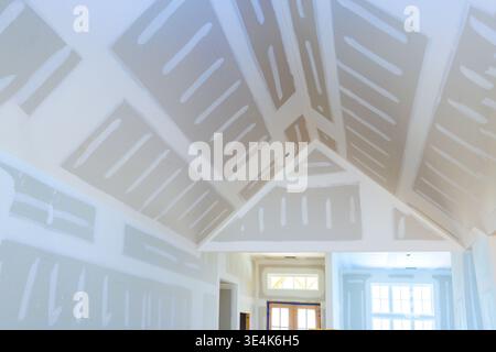 Workers have installed drywall in interior of house, with lines seams on walls ceiling. Stock Photo