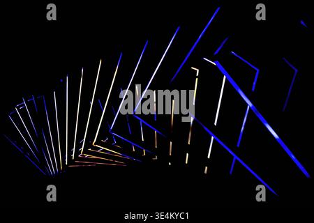 Angular blue and white glowing lines recede into a dark background, creating a strong sense of depth. Stock Photo