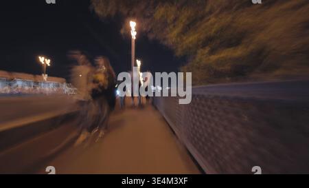Abstract long exposure of people walking on a city street at night Stock Photo