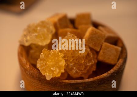 A Beautiful Display of Natural Sweeteners Including Sugar Cubes and Rock Candy in a Decorative Wooden Bowl Stock Photo