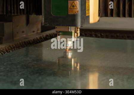 Precision Cutting: A Laser Engraver at Work on a Metal Surface Creating Intricate Designs with High Accuracy Stock Photo