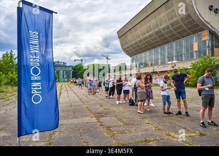 A long queue of people waits outside the Palace of Concerts and Sports in Vilnius, Lithuania, during the Open House Vilnius event. In the foreground, Stock Photo