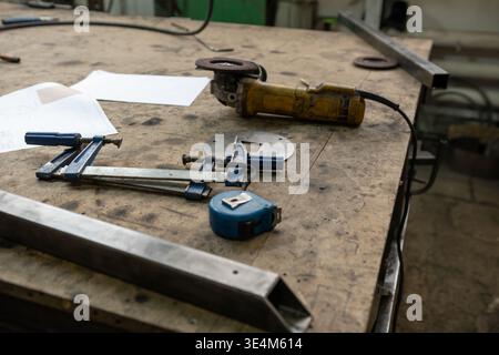 Tools and Equipment on a Workbench Displaying Various Measuring and Cutting Instruments in a Workshop Environment Stock Photo