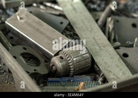 A Chaotic Collection of Various Metal Tools, Fasteners, and Measuring Instruments in a Workshop Environment Stock Photo