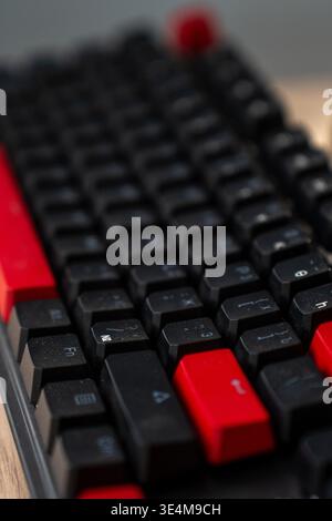 A Close-Up View of a Black and Red Mechanical Keyboard with Distinctive Keys and Textures for Gaming or Typing Stock Photo