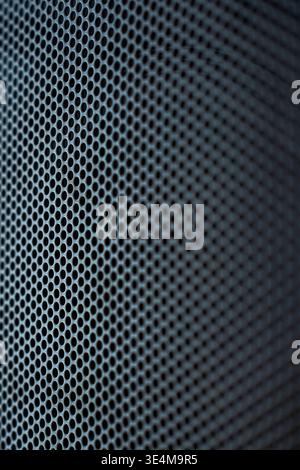 Detailed Close-Up of a Mesh Speaker Grille Showcasing Circular Patterns and Textures in Shades of Black and Gray Stock Photo