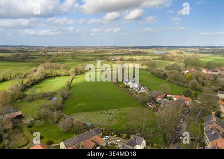 Wide aerial view of fields and farmland around Bishop Monkton village with houses along a rural road and hedgerows showing open countryside landscape Stock Photo