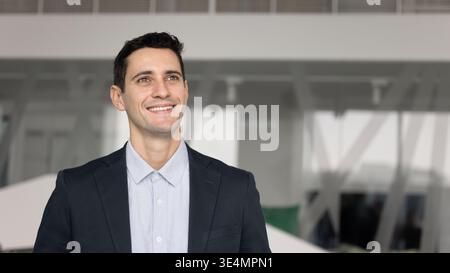 Headshot portrait Hispanic male professional looking away with happy smile Stock Photo