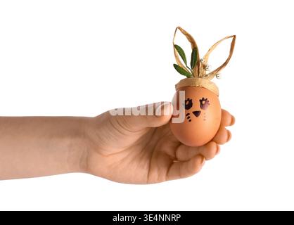 Female hand with creative Easter egg on white background Stock Photo