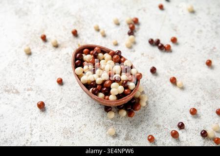 Sweet chocolate egg full of candies on white background Stock Photo