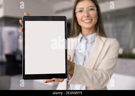 Closeup businesswoman holds digital tablet with white mock up Stock Photo