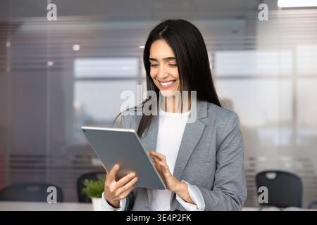 Smiling businesswoman working online using digital tablet Stock Photo