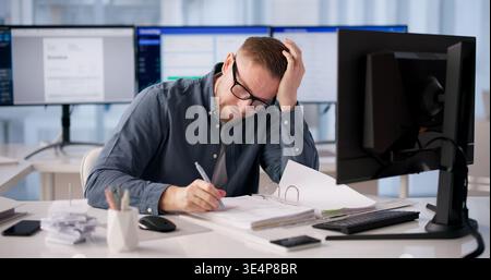 Accountant Battles Software Glitches Leading To Stress And Fatigue Stock Photo