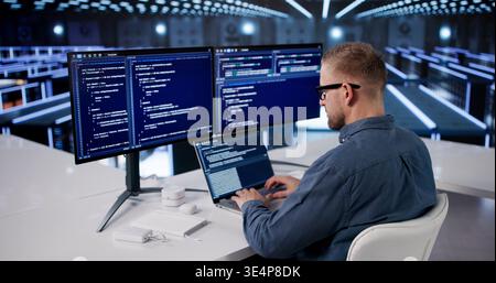 IT Professional Managing Cloud Data Protection In Advanced Server Facility Stock Photo