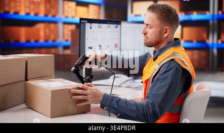 Warehouse Employee Checking Barcode Tags On Boxes For Stock Management Stock Photo