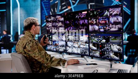 Military Officer Analyzing Satellite Intelligence In A Secure Cyber Operations Center Stock Photo