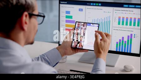 Efficient Leader Skillfully Juggles Multiple Tasks Amid Busy Office Environment Stock Photo